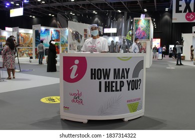 Dubai, UAE - October 10, 2020: Customer Service Personnel Wearing Face Shield And Face Mask As A Health Precaution At 'World Art Dubai' Affordable Retail Art Fair, During The Global Covid-19 Pandemic.