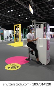 Dubai, UAE - October 10, 2020: Customer Service Personnel Wearing Face Shield And Face Mask As A Health Precaution At 'World Art Dubai' Affordable Retail Art Fair, During The Global Covid-19 Pandemic.