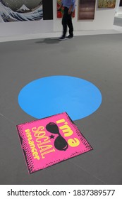 Dubai, UAE - October 10, 2020: Decal/sticker Sign Instructs Visitors To Maintain Social Distance As A Stipulated Health Precaution At 'World Art Dubai' Retail Art Fair, During The Covid-19 Pandemic.