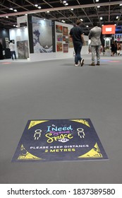 Dubai, UAE - October 10, 2020: Decal/sticker Sign Instructs Visitors To Maintain Social Distance As A Stipulated Health Precaution At 'World Art Dubai' Retail Art Fair, During The Covid-19 Pandemic.