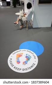 Dubai, UAE - October 10, 2020: Decal/sticker Sign Instructs Visitors To Maintain Social Distance As A Stipulated Health Precaution At 'World Art Dubai' Retail Art Fair, During The Covid-19 Pandemic.