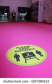 Dubai, UAE - October 10, 2020: Decal/sticker Sign Instructs Visitors To Maintain Social Distance As A Stipulated Health Precaution At 'World Art Dubai' Retail Art Fair, During The Covid-19 Pandemic.