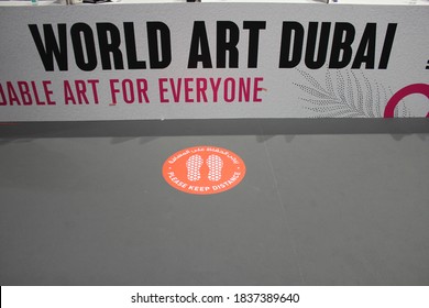 Dubai, UAE - October 10, 2020: Decal/sticker Sign Instructs Visitors To Maintain Social Distance As A Stipulated Health Precaution At 'World Art Dubai' Retail Art Fair, During The Covid-19 Pandemic.