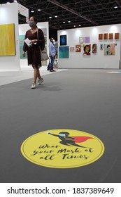 Dubai, UAE - October 10, 2020: Decal/sticker Sign Instructs Visitors To Maintain Social Distance As A Stipulated Health Precaution At 'World Art Dubai' Retail Art Fair, During The Covid-19 Pandemic.