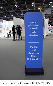 Dubai, UAE - October 10, 2020: Notice Sign In 2 Languages Instructs Visitors To Use Hand Sanitizer As A Health Precaution At 'World Art Dubai' Retail Art Fair, During The Global Covid-19 Pandemic.