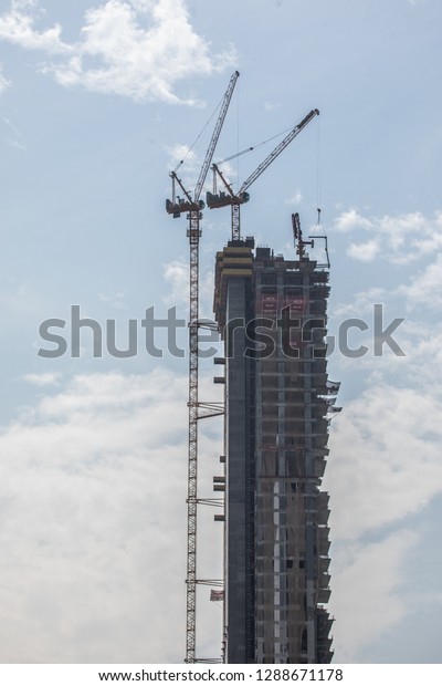 Dubai, UAE - October, 2018: Construction\
worker in Dubai Marina in a summer\
day.