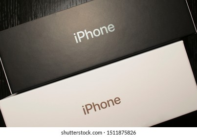 Dubai / UAE - September 21, 2019: Two black and white apple iphone boxes on wooden background. iphone 11 pro 