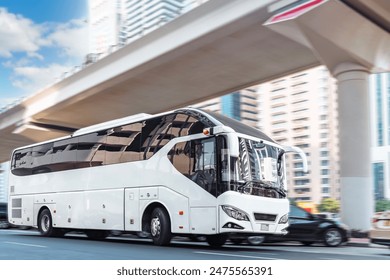 Dubai, UAE. White tourist bus on a city street.