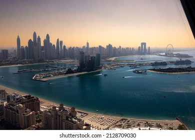 Dubai, UAEmirates - febr 24 2022: View from the 240m high observation deck of the new Palm Tower. Complete skyline of Dubai Marina and Emaar Beach Front in a misty sunset
