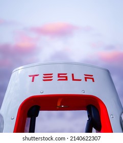 Dubai, United Arab Emirates—March 29th, 2022: Photograph of a Tesla Supercharger with a beautiful cloudy sky background