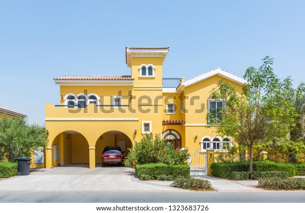 Dubai / United Arab Emirates -\
02-26-2019 : state of the art, big yellow villa house in dubai, in\
the villa project Dubai. Private covered car parking also\
avaialbe