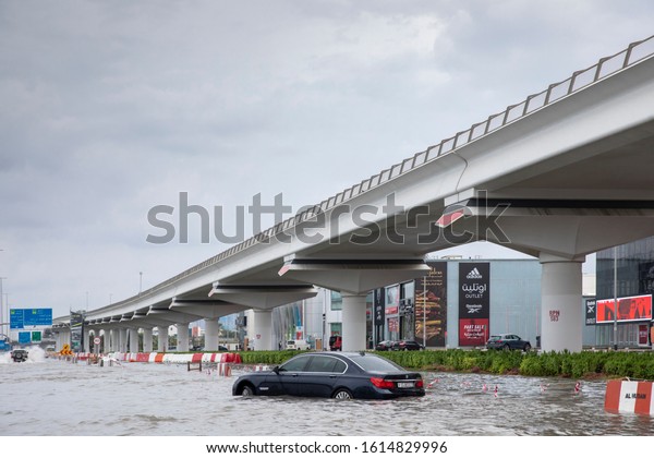 Dubai, United Arab\
Emirates, 11 January 2020: car driving in flooded street of Dubai\
after a heavy rainfall