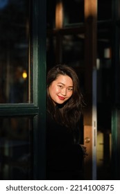 Dubai, United Arab Emirates - 2 February 2018: Pretty Southeast Asian Woman With Dark Wavy Hair And Red Lips Smiles At The Camera. Female Is Outdoors On A Beautiful Summer Day, The Sun On Her Face.