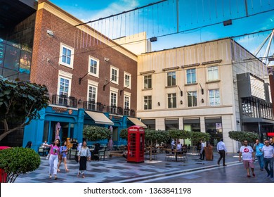 Dubai, United Arab Emirates; 6 April 2019; City Walk; Visitors Crossing Pathway. Vintage Buildings, London Telephone Booth, Traditional Old Style UK Red Phone Box