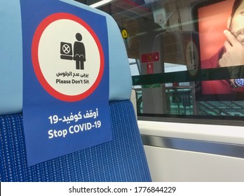 Dubai, United Arab Emirates- April 29, 2020: Awareness stickers on the seats Dubai Metro Trains, requesting passengers, Arabic means: Please don't sit, Stop COVID-19" to stop spreading corona virus