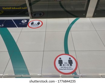 Dubai, United Arab Emirates- April 30, 2020: Awareness Stickers On The Floor Inside Dubai Metro Train, Requesting Passengers, Arabic Means: Keep Safe Distance Distance