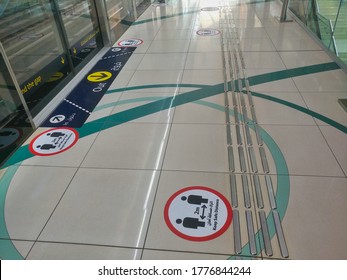 Dubai, United Arab Emirates- April 30, 2020: Awareness Stickers On The Floor Inside Dubai Metro Train, Requesting Passengers, Arabic Means: Keep Safe Distance Distance