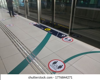 Dubai, United Arab Emirates- April 30, 2020: Awareness Stickers On The Floor Inside Dubai Metro Train, Requesting Passengers, Arabic Means: Keep Safe Distance Distance