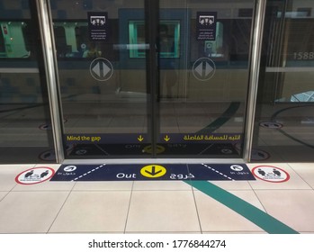 Dubai, United Arab Emirates- April 30, 2020: Awareness Stickers On The Floor Inside Dubai Metro Train, Requesting Passengers, Arabic Means: Keep Safe Distance Distance