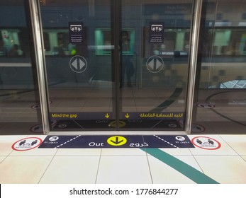 Dubai, United Arab Emirates- April 30, 2020: Awareness Stickers On The Floor Inside Dubai Metro Train, Requesting Passengers, Arabic Means: Keep Safe Distance Distance