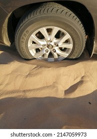 Dubai, United Arab Emirates - April 18, 2022: Off-road 4x4 Vehicle (four-wheel-drive, 4WD, SUV) Sinking And Stuck In Deep Desert Sand Dunes Terrain. The Vehicle Needs To Be Towed Out Or Shoveled Out.