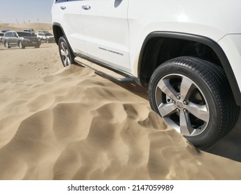 Dubai, United Arab Emirates - April 18, 2022: Off-road 4x4 Vehicle (four-wheel-drive, 4WD, SUV) Sinking And Stuck In Deep Desert Sand Dunes Terrain. The Vehicle Needs To Be Towed Out Or Shoveled Out.