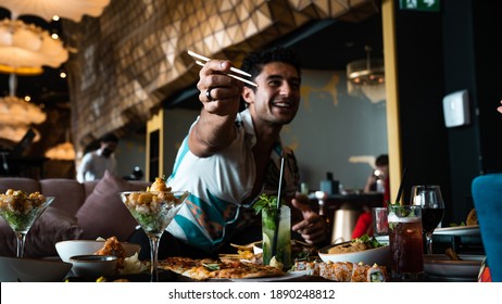 Dubai, United Arab Emirates- Aug 20 2020:  Man Eating Sushi. Restaurant Airport Lounge Bar Food Drinks Sushi