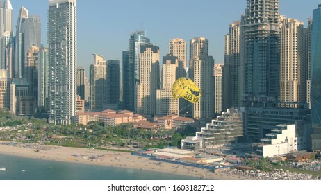 DUBAI, UNITED ARAB EMIRATES - DECEMBER 26, 2019. Aerial Shot Of SeaWake Parasailing On Skyscrapers And Beach Background