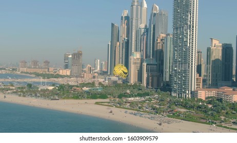 DUBAI, UNITED ARAB EMIRATES - DECEMBER 26, 2019. Aerial View Of SeaWake Parasailing Against Waterfront Skyscrapers And Beach