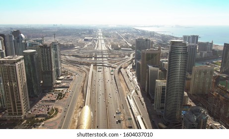 DUBAI, UNITED ARAB EMIRATES - DECEMBER 26, 2019. Aerial Shot Of DEWA Jebel Ali Power Plant And Desalination Complex Behind Modern Skyscrapers