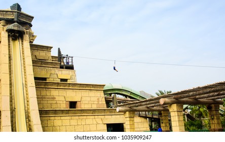 Dubai, United Arab Emirates - February 24, 2018: Tourist On The Zip Line In Atlantis Water Park On The Palm Jumeirah Island In The UAE