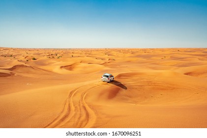 Dubai, United Arab Emirates - January 2020: The car ride at Arabian Desert over the dunes. A warm day in the desert.