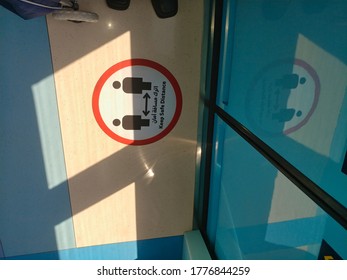 Dubai, United Arab Emirates- June 5, 2020: Awareness Stickers On The Floor Inside Dubai Metro Train, Requesting Passengers, Arabic Means: Keep Safe Distance Distance