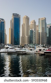 DUBAI, UNITED ARAB EMIRATES - JUNE 25, 2016: Modern skyscrapers and embankment in famous Dubai Marina. Marina - artificial canal city, carved along a 3 km stretch of Persian Gulf shoreline.