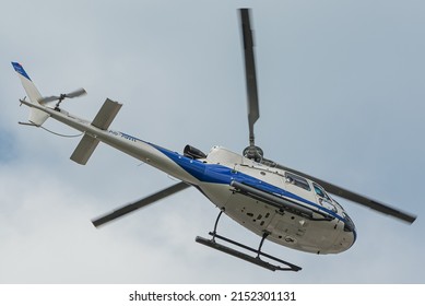 DUBAI, UNITED ARAB EMIRATES - Mar 12, 2022: A low angle shot of a Helicopters Heli Dubai Tours Aerospatiale AS AS350 Ecureuil in the blue sky
