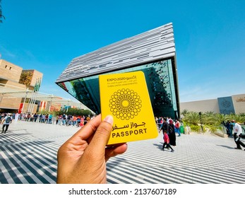 Dubai, United Arab Emirates- March 6, 2022: Male Tourist Hand Holding Expo 2020 Passport In Front Of Saudi Arabia Pavilion At EXPO 2020 Dubai. Being Held From October 1, 2021 To March 31, 2022