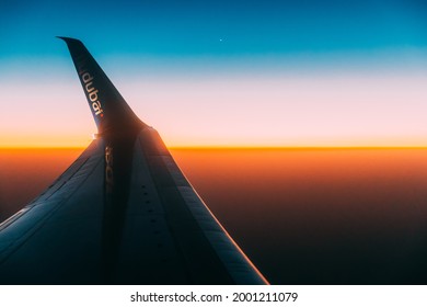 Dubai, United Arab Emirates - May 29, 2021: Close View Of Logotype Flydubai On Wing Of Aircraft. Plane At Sunset Sky. View From Airplane Window On Height Flight Of Plane. Travel And Transportation