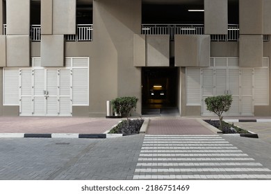 Dubai, United Arab Emirates - May 26, 2017: Exterior Of A Modern Multi-storey Carpark In The City's Financial District. Ground View From A Crosswalk. Urban Day Scene. Horizontal Background Copy Space.