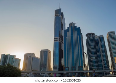 DUBAI, UNITED ARAB EMIRATES - OCTOBER 16, 2019: Dubai Skyline At Sunset With Metro Line On E 11 Road On Foreground.