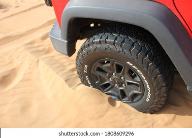 Dubai, United Arab Emirates - September 4, 2020: All-terrain tire on a Jeep Wrangler 4x4/SUV in desert sand dunes. Tire is deflated to low pressure to provide extra traction in the soft desert sand.