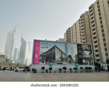 Dubai, United Arab Emirates - September 14, 2021: Large outdoor advertising (out of home) billboard (hoarding) panel with marketing campaign on a street in Dubai city. Roadside advertising concept.