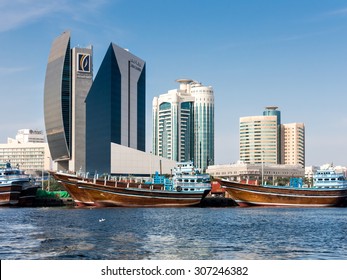 DUBAI, UNITED ARAB EMIRATES (UAE) - JAN 26, 2014: Dhows And The Buildings Of National Bank Of Dubai, Dubai Creek Tower And Al Reem Tower In Rigga Al Buteen Central Business District, Deira, The Creek