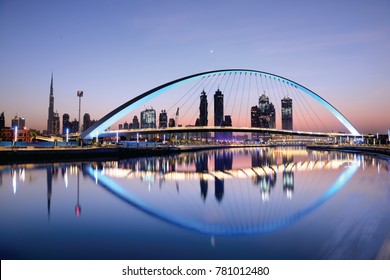 Dubai water canal at sun rise and colorful  bridge as viewed Dubai, United Arab Emirates on November 2017 - Powered by Shutterstock