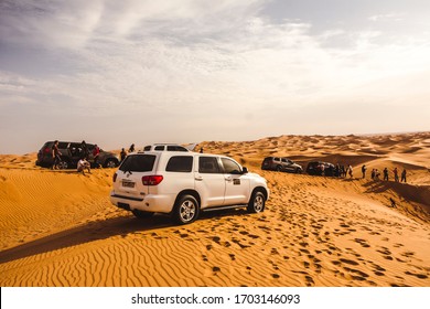Dubai. Year 2019: 4x4 trucks in the dunes of the Dubai desert. This is an adrenaline rush experience. A speed safari through the Arabian desert. SUV car in sand.