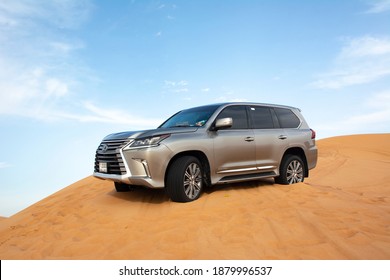 Dubai, Year 2019: Luxury SUV making off road in the desert. Lexus LX on the sand.