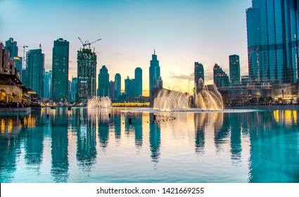 Dubai-3/16/2018- Dubai mall water fountain water dance colorful sunset at world tallest building Burj Khalifa 