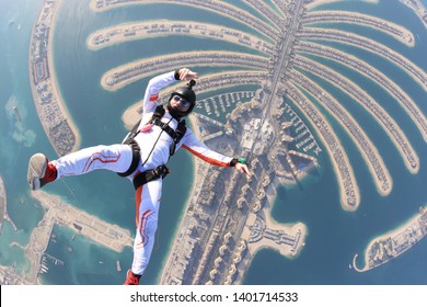 Dubai.People lies on beach Dubai Palm in free fall sky jump. Sea outdoor skydiving travel man. Free fall extreme action sky man on speed 200km.h. Summer fly beach sky man advertising business.