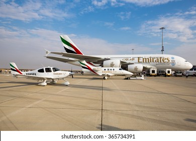 DUBAI,UAE - NOVEMBER 12, 2015: Emirates airline Airbus A380. Dubai Airshow 2015. Emirates flight training academy airplanes Embraer EMB-500 Phenom 100, Cirrus SR22.