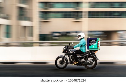 Dubai/UAE - September 20, 2019: A delivery man riding a bike with motion panning
