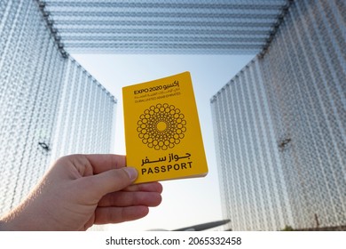 Dubai-UAE-OCT-27-2021: A Person Holding The  Yellow Passport At The Entrance Gate Of The Dubai Expo Gate